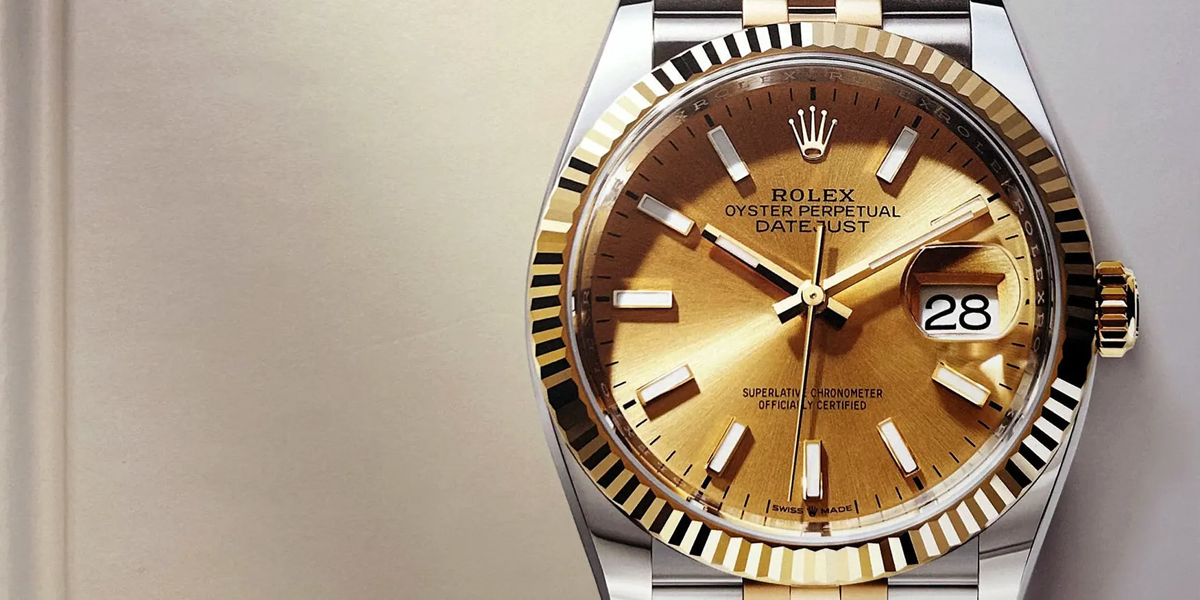 Rolex Oyster Perpetual Datejust with a champagne dial and fluted gold bezel